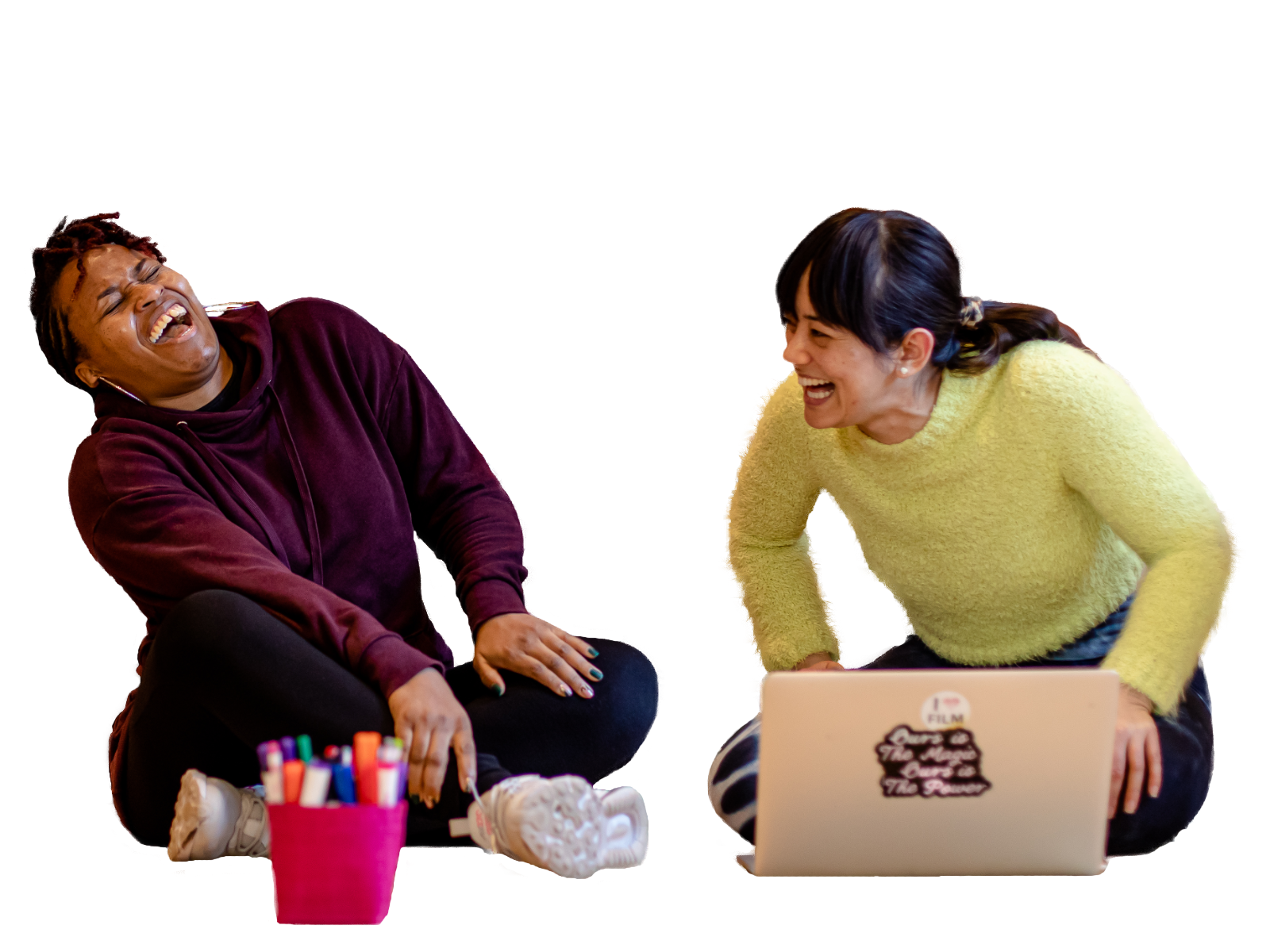 Two women sat crossed leg laughing