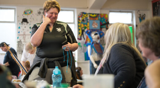 Smiling woman participating in a crafting session