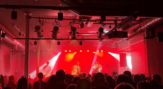 Crowd watching a band play in a crowded venue