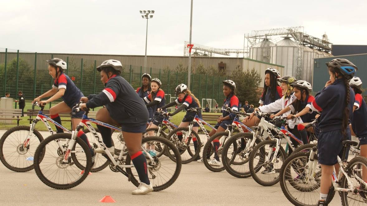 Group of young people on bikes in helmets