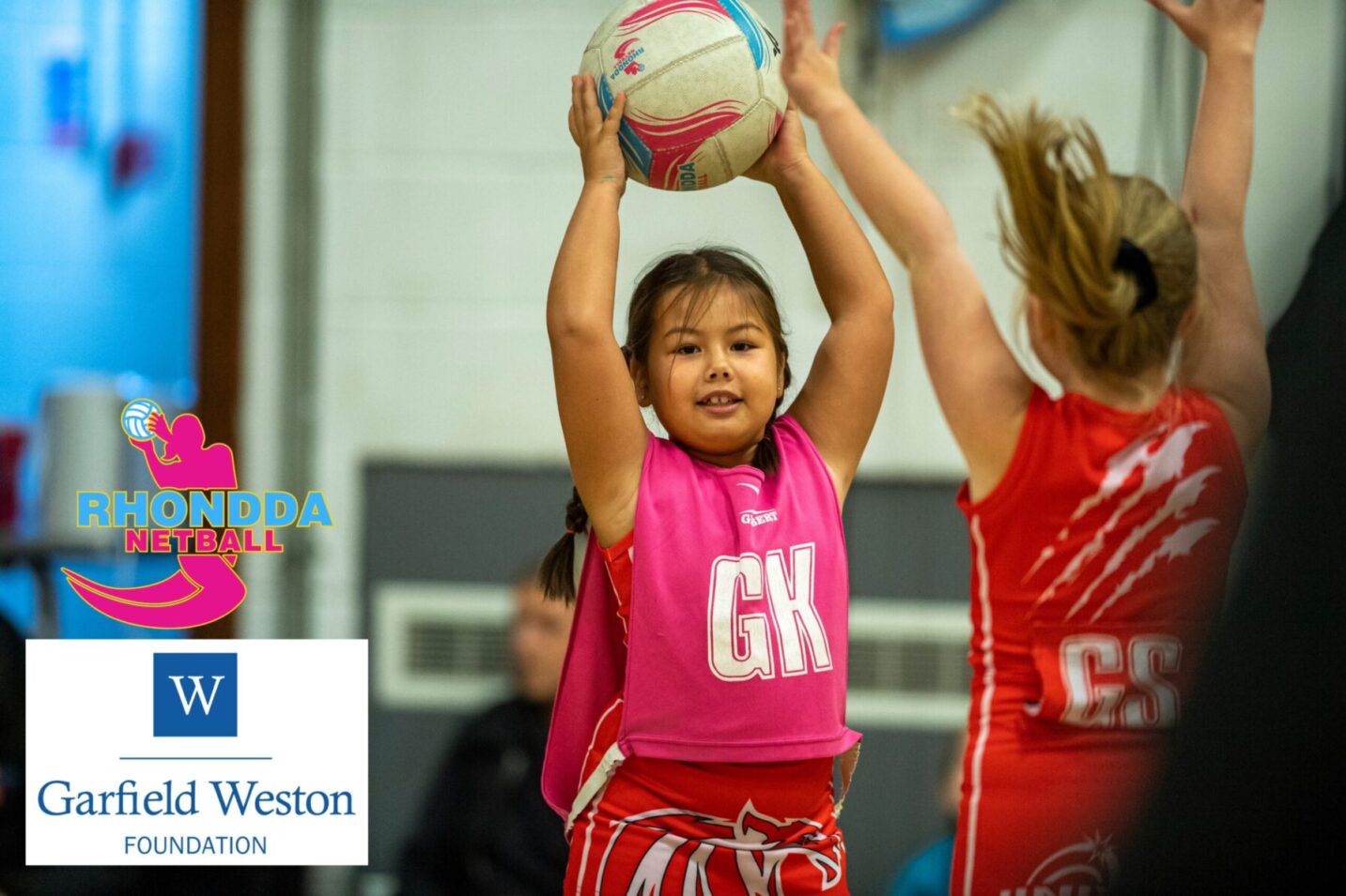 Two girls playing netball