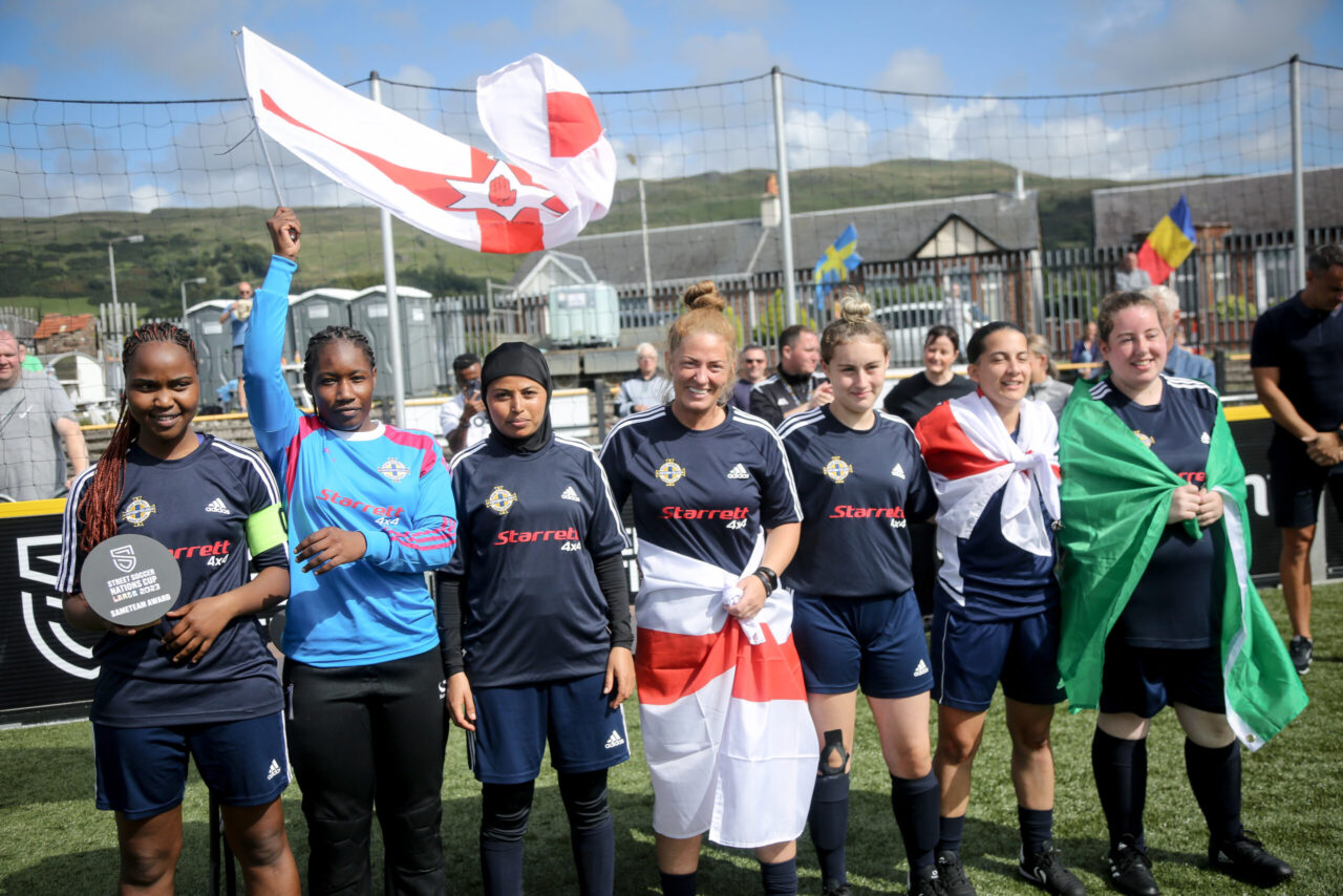 Group of five young women in football kit